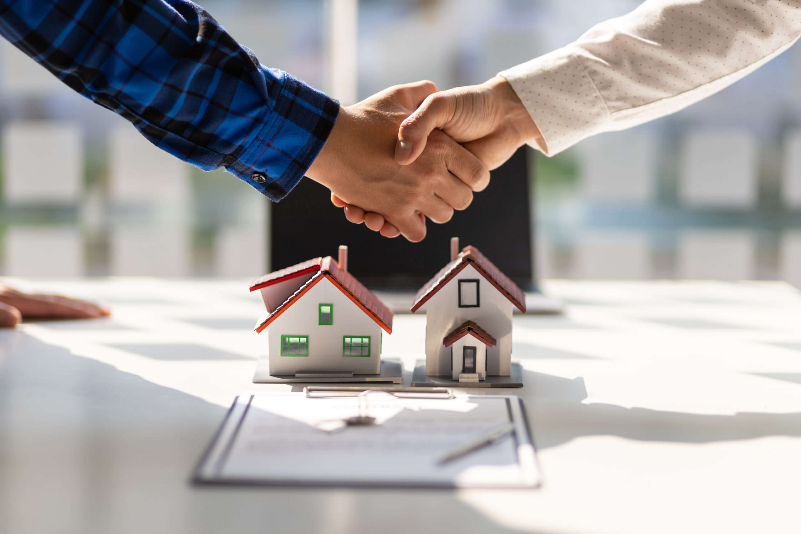 Hausmodelle auf Mietvertrag mit geschüttelten Händen © Wasan Tita iStock Getty Images Plus