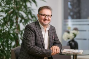 Mann mit Brille in dunklem Anzug